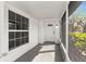 Covered front porch with decorative flooring and a view of the front door and window at 2027 59Th N St, Clearwater, FL 33760