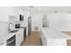 Bright, spacious kitchen with an island, white cabinets, stainless steel appliances, and wood flooring at 2027 59Th N St, Clearwater, FL 33760