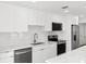 Modern kitchen featuring white cabinets, stainless steel appliances, and stylish marble countertops at 2027 59Th N St, Clearwater, FL 33760
