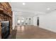 Cozy living room with stone fireplace and French doors leading to an outdoor area at 2027 59Th N St, Clearwater, FL 33760