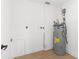 Utility room with modern water heater, utility sink hookup, and white walls at 2027 59Th N St, Clearwater, FL 33760
