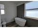 Modern bathroom showcasing a freestanding tub, sleek tile work, and abundant natural light, creating a spa-like retreat at 23458 Macbeth Ct, Punta Gorda, FL 33980