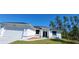 Beautiful single-story home with a well-maintained lawn and an attached two-car garage at 23458 Macbeth Ct, Punta Gorda, FL 33980