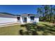Well manicured front lawn and sidewalk leading up to the front door at 23458 Macbeth Ct, Punta Gorda, FL 33980