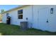 HVAC unit on the outside of the house with a door at 23458 Macbeth Ct, Punta Gorda, FL 33980