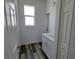 This bright laundry room offers extra storage space with shaker cabinets and a bright window at 23458 Macbeth Ct, Punta Gorda, FL 33980