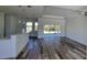 Bright, open-concept living area with stylish floors and seamless flow to the outdoors, perfect for modern living at 23458 Macbeth Ct, Punta Gorda, FL 33980