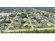 Expansive aerial capture shows a vibrant residential area with varied housing styles, pools, and verdant spaces near a lake at 23531 Dunstan Ave, Port Charlotte, FL 33954