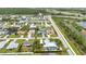 A birds-eye view of a suburban community showcasing lovely homes with screened-in pools and manicured landscaping at 23531 Dunstan Ave, Port Charlotte, FL 33954