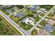 Aerial view showcases a property with a screened pool, garage, and nice landscaping in a neighborhood setting at 23531 Dunstan Ave, Port Charlotte, FL 33954