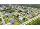 Scenic aerial view of a well-planned neighborhood with diverse home styles, manicured lawns, and convenient street access at 23531 Dunstan Ave, Port Charlotte, FL 33954