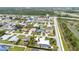 Overhead shot showcases a neighborhood with varied homes, easy road access, and bordered by lush green areas at 23531 Dunstan Ave, Port Charlotte, FL 33954