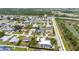 Expansive aerial view of a residential neighborhood featuring well-maintained homes and lush green lawns at 23531 Dunstan Ave, Port Charlotte, FL 33954