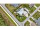 Aerial view of a single-Gathering home with a screened pool, attached garage, and well-manicured lawn and landscaping at 23531 Dunstan Ave, Port Charlotte, FL 33954