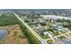 Panoramic aerial shot displays a lakeside neighborhood with lush landscaping, diverse homes, and a natural wetland area nearby at 23531 Dunstan Ave, Port Charlotte, FL 33954