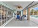 Relaxing back porch with tile flooring, ceiling fan and seating overlooking the pool at 23531 Dunstan Ave, Port Charlotte, FL 33954