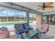 Inviting back porch featuring tile flooring, ceiling fan and lounge seating overlooking the pool at 23531 Dunstan Ave, Port Charlotte, FL 33954
