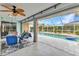Comfortable back porch featuring tile flooring, ceiling fan and overlooking the pool at 23531 Dunstan Ave, Port Charlotte, FL 33954
