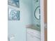 Cozy powder room featuring charming starfish wall art and a decorative mirror at 23531 Dunstan Ave, Port Charlotte, FL 33954
