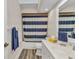 Bright bathroom featuring a blue and white striped shower curtain at 23531 Dunstan Ave, Port Charlotte, FL 33954