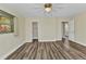 Spacious bedroom with wood-look floors, closet, and ensuite bathroom at 23531 Dunstan Ave, Port Charlotte, FL 33954