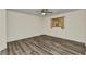 Neutral bedroom with wood-look floors, window, and ceiling fan at 23531 Dunstan Ave, Port Charlotte, FL 33954