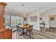 Bright dining area features wood-look flooring, decorative lighting, and a large window for natural light at 23531 Dunstan Ave, Port Charlotte, FL 33954