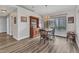 Cozy dining area with natural light, wood-look flooring, and a rustic hutch for storage at 23531 Dunstan Ave, Port Charlotte, FL 33954
