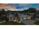 Stunning home with beautiful landscaping, RV shelter, and a picturesque sunset backdrop at 23531 Dunstan Ave, Port Charlotte, FL 33954