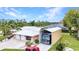 Well-maintained home featuring a large RV shelter, two-car garage, and tropical landscaping at 23531 Dunstan Ave, Port Charlotte, FL 33954