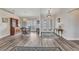 Spacious foyer featuring beautiful flooring, elegant double doors, and a view into the dining area at 23531 Dunstan Ave, Port Charlotte, FL 33954
