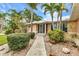 Inviting home exterior with lush landscaping and a charming walkway leading to the front entrance at 23531 Dunstan Ave, Port Charlotte, FL 33954
