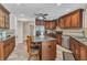Kitchen featuring an island with granite countertop, stainless steel appliances, and wood cabinets at 23531 Dunstan Ave, Port Charlotte, FL 33954