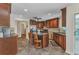 Spacious kitchen boasts a granite island with seating, stainless steel appliances, and wood cabinets at 23531 Dunstan Ave, Port Charlotte, FL 33954