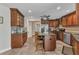 Kitchen features a granite island with seating, stainless steel appliances, and tile floors at 23531 Dunstan Ave, Port Charlotte, FL 33954