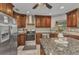 Well appointed kitchen boasts stainless steel appliances, granite countertops, and beautiful wood cabinetry at 23531 Dunstan Ave, Port Charlotte, FL 33954