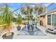 Outdoor living at its finest with a screened lanai with dining and a view of the backyard at 23531 Dunstan Ave, Port Charlotte, FL 33954