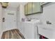 Inside laundry room with white washer and dryer and cabinets for storage at 23531 Dunstan Ave, Port Charlotte, FL 33954