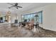 Living room with tile flooring, bay window, and a ceiling fan for added comfort at 23531 Dunstan Ave, Port Charlotte, FL 33954
