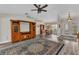Open-concept living area showcasing hardwood floors, a vaulted ceiling, and views into the dining room at 23531 Dunstan Ave, Port Charlotte, FL 33954