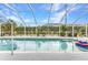 Large screened in pool with a clear blue water and landscaped backyard at 23531 Dunstan Ave, Port Charlotte, FL 33954