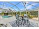 Lanai includes dining and seating overlooking the inviting pool and the scenic landscape at 23531 Dunstan Ave, Port Charlotte, FL 33954