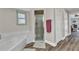 Shower with frosted glass door in bathroom with white bath mat at 23531 Dunstan Ave, Port Charlotte, FL 33954