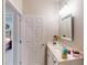 Bright bathroom with a single sink vanity and a doorway to the bedroom at 2436 Arugula Dr, North Port, FL 34289