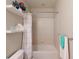 Clean bathroom featuring a shower-tub combo and decorative shelving at 2436 Arugula Dr, North Port, FL 34289