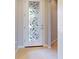 Bright foyer featuring a decorative glass door and neutral tile flooring at 2436 Arugula Dr, North Port, FL 34289