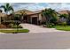 Beautiful single-story home with a well-manicured lawn and lush landscaping at 2436 Arugula Dr, North Port, FL 34289