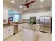 Modern kitchen with stainless steel appliances, granite counters, and center island at 2436 Arugula Dr, North Port, FL 34289