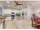 Bright kitchen features stainless steel appliances, granite countertops and center island at 2436 Arugula Dr, North Port, FL 34289