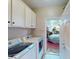 Laundry room with washer, dryer, and access to garage at 2436 Arugula Dr, North Port, FL 34289